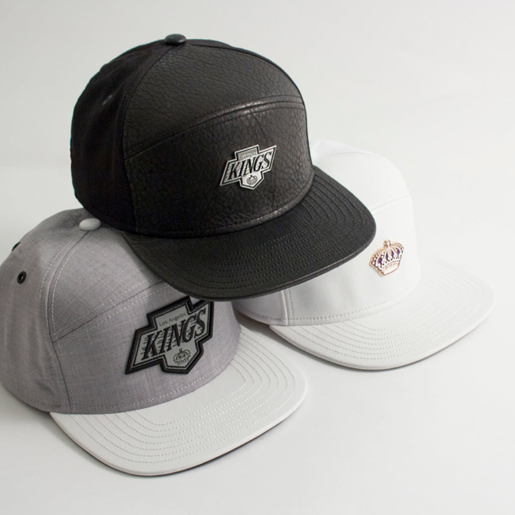 Three melin caps with 'Kings' logo on a light gray background