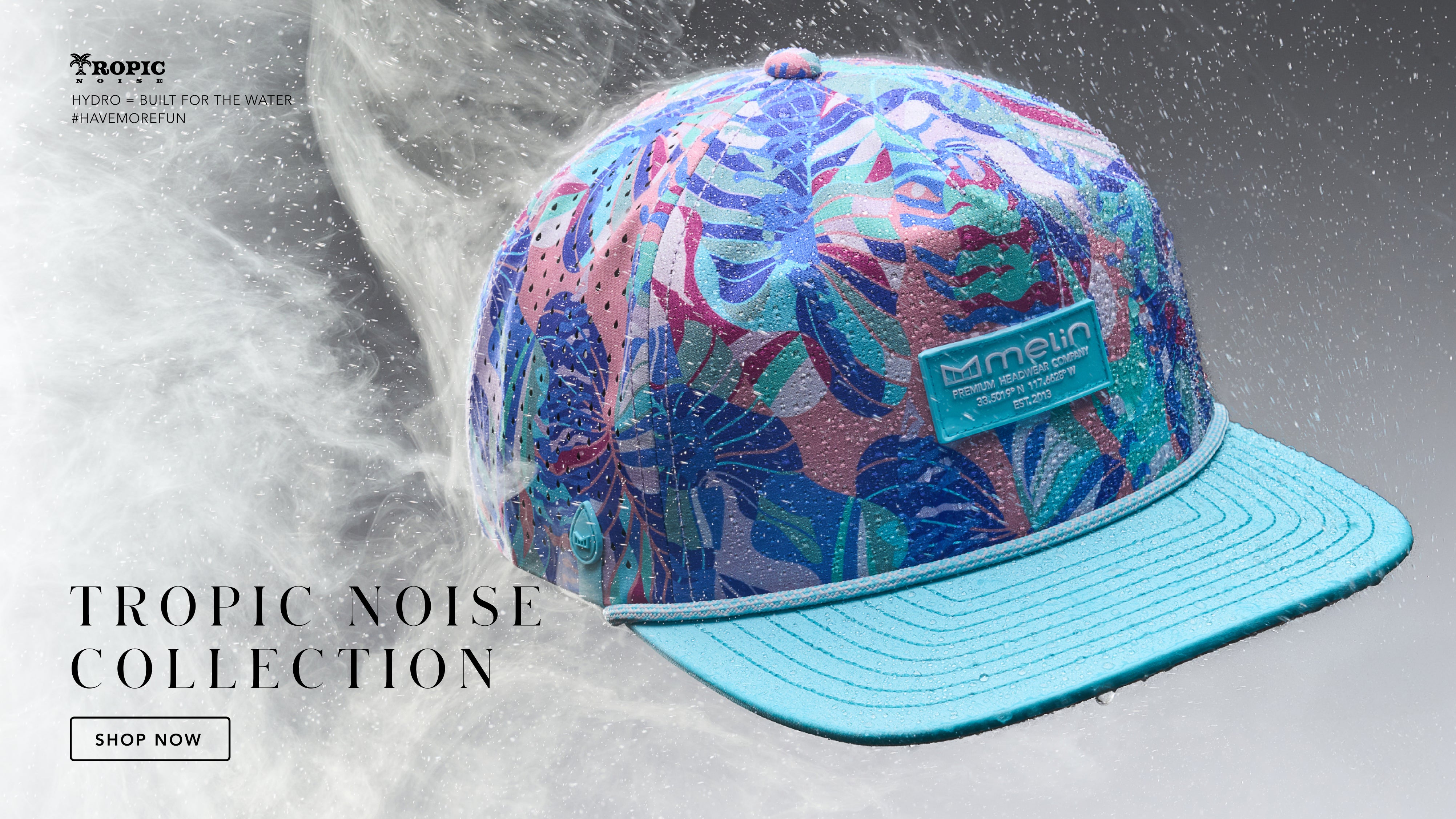 Colorful patterned cap with blue brim on a gray background, featuring 'Tropic Noise Collection' text.
