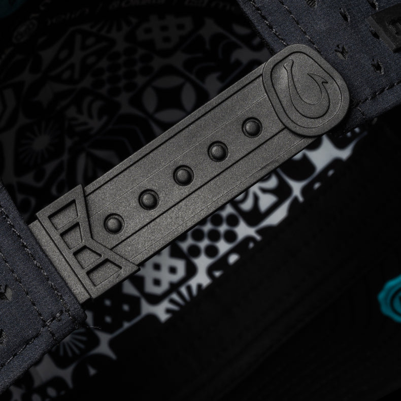 Close-up of a black leather strap with embossed design on a dark background