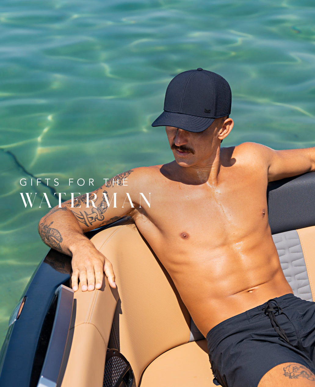 Man wearing the A-Game Hydro sitting on a boat with clear water in the background, promoting 'Gifts for the Waterman'.
