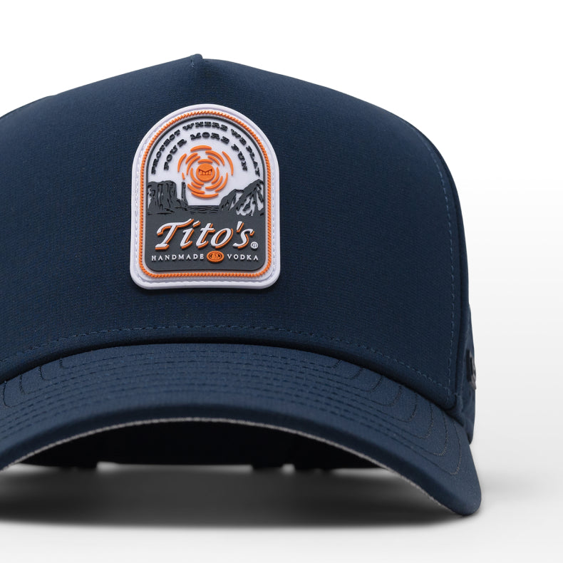 Navy blue melin cap with Tito's Handmade Vodka logo on a white background