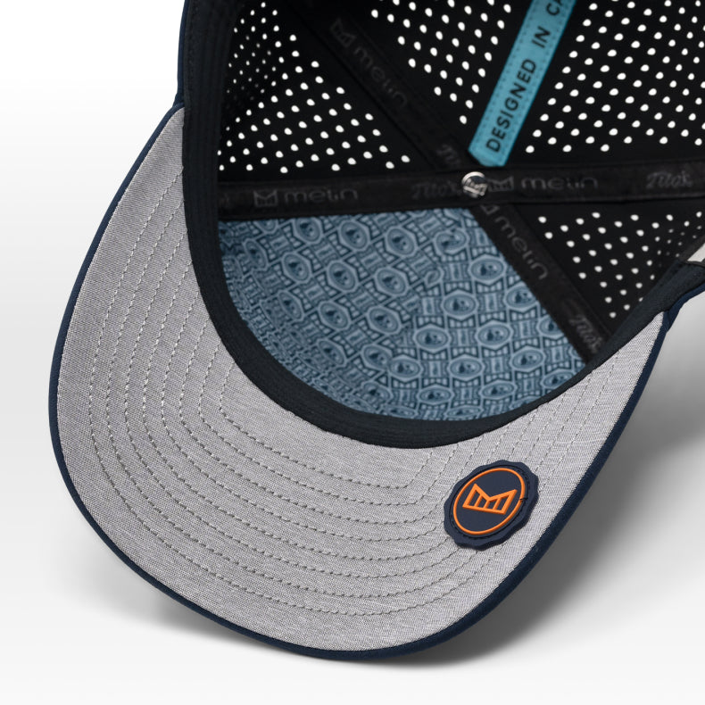 Close-up of the melin x Tito's with a patterned visor and brand logo on a white background