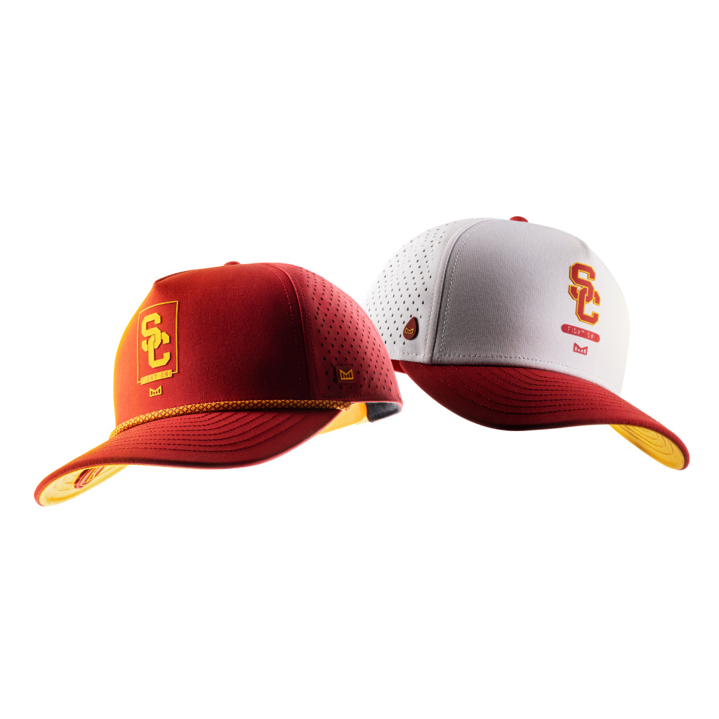 Two USC x melin branded caps on a white background